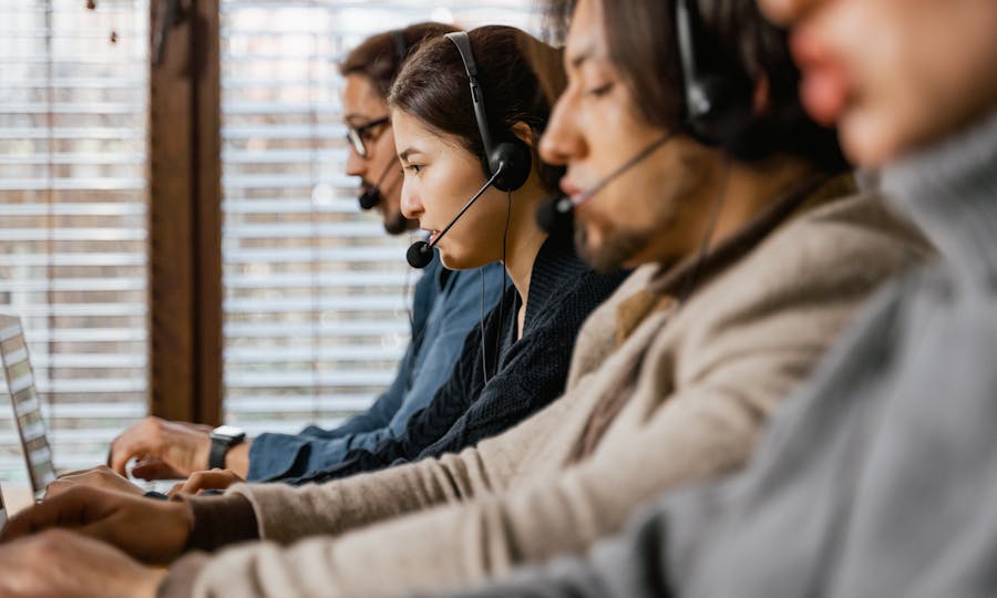 Support team using headsets and laptops to handle ongoing service requests